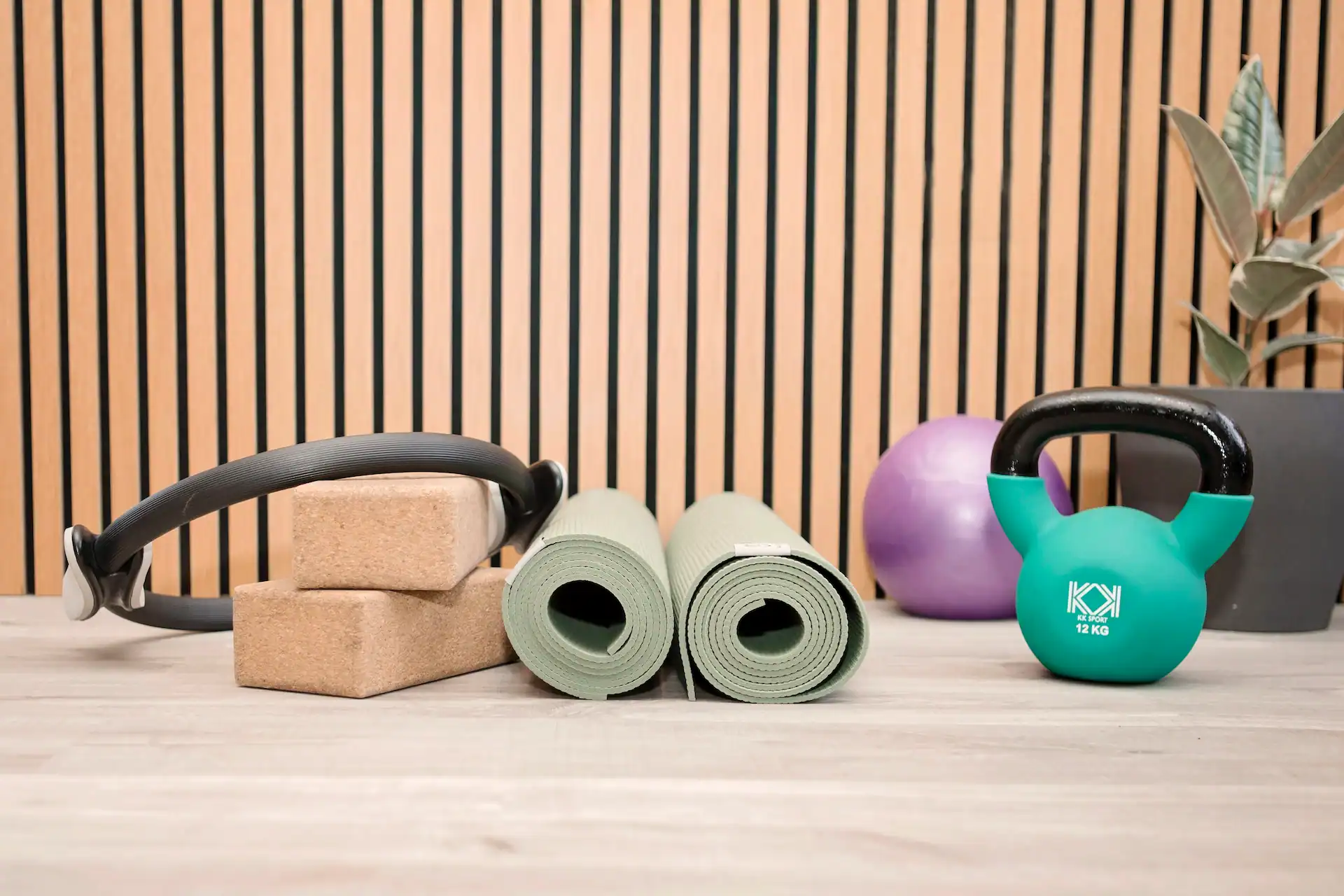 Kettlebell, yoga mats, and blocks for Pilates exercises.