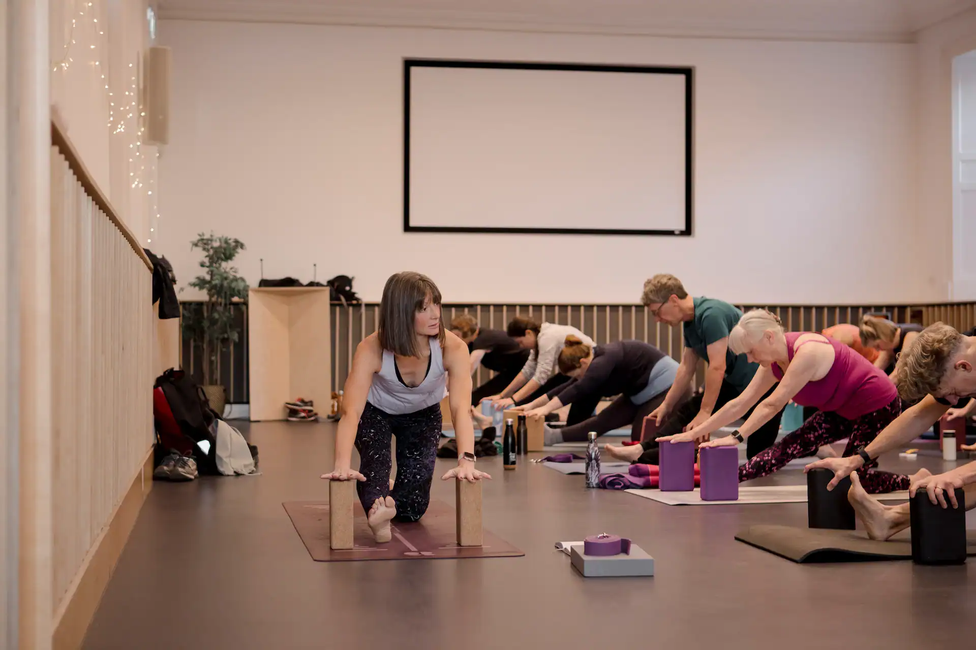 Group Pilates class focusing on flexibility and strength with instructor Tess.